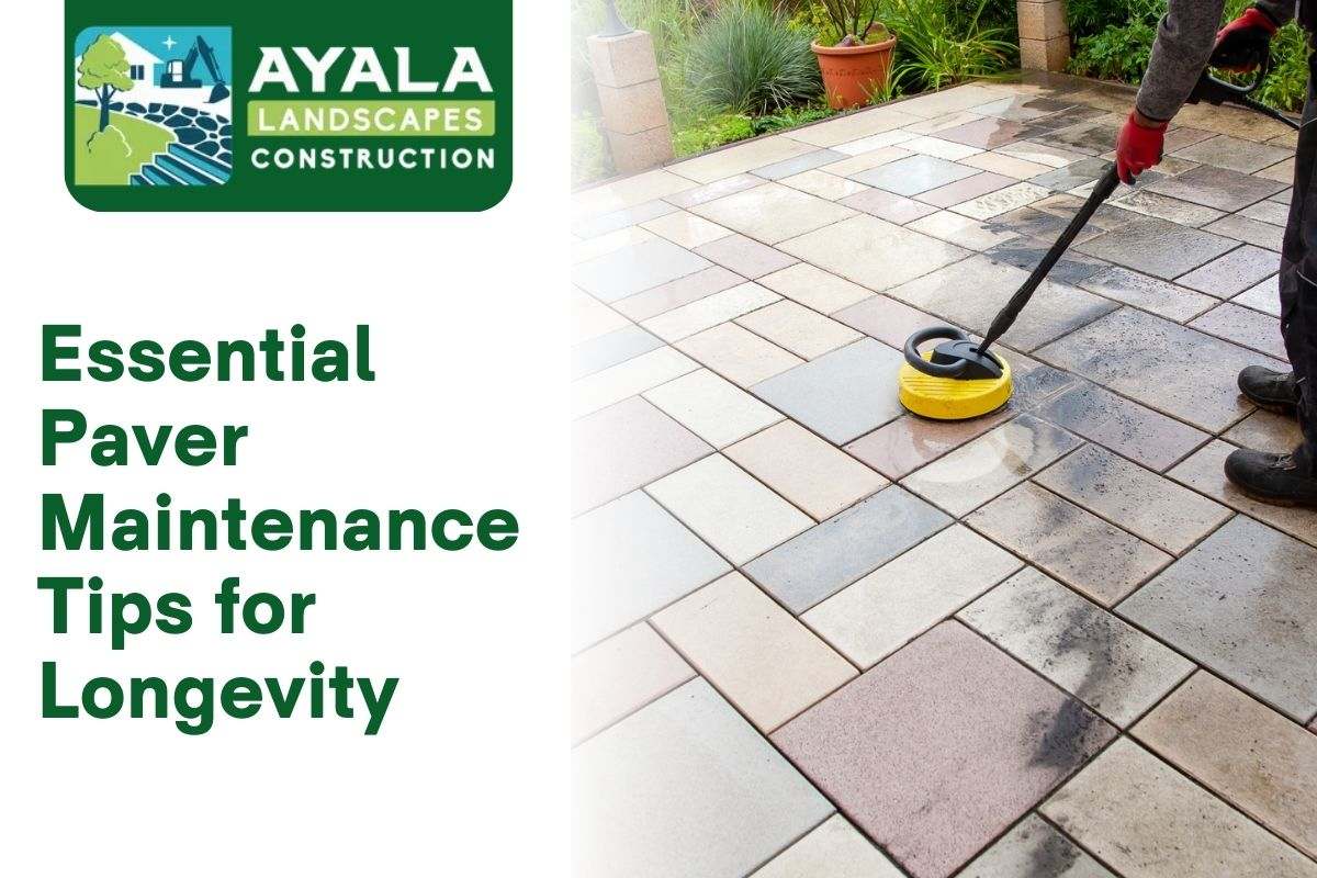 A person using a hose to clean dirt off patio pavers in Spanaway.